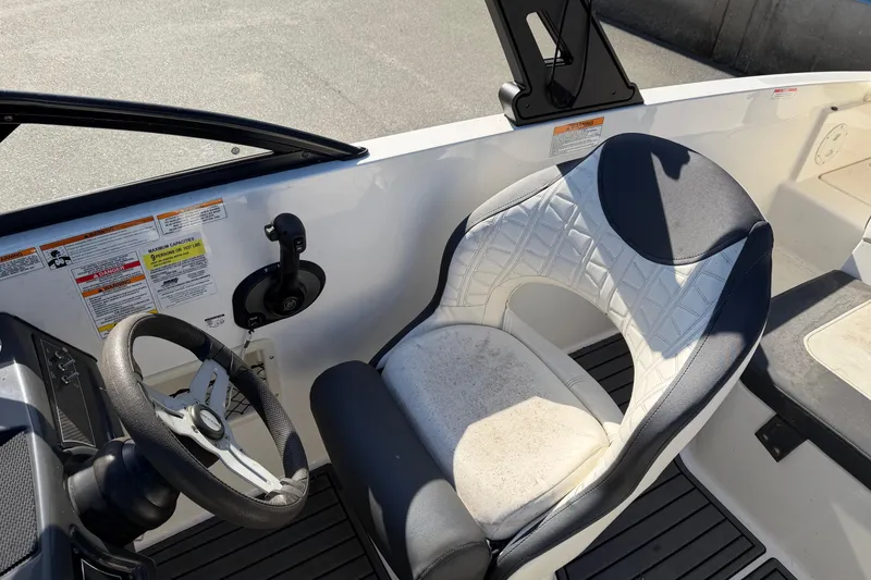Slide: The Image of 2021 Bayliner VR5 Bowrider OB cockpit with steering wheel and cushioned seat. - 4
