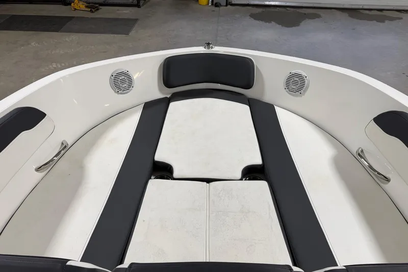 Slide: The Image of 2021 Bayliner VR5 Bowrider OB interior with cushioned seating and built-in speakers. - 9