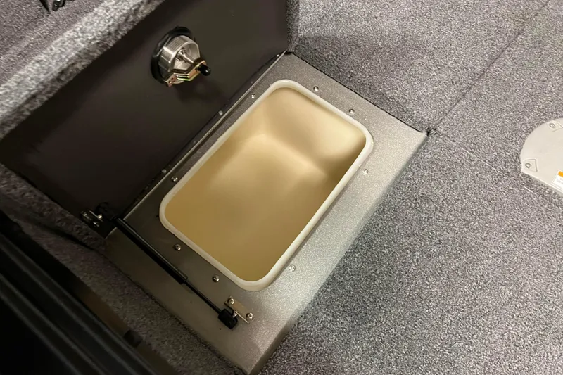 Slide: The Image of 2023 Lund 2175 Pro-V boat storage compartment with open lid, showcasing interior details. - 17