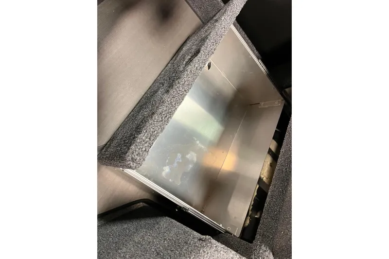 Slide: The Image of 2023 Lund 2175 Pro-V boat storage compartment with carpeted interior. - 37