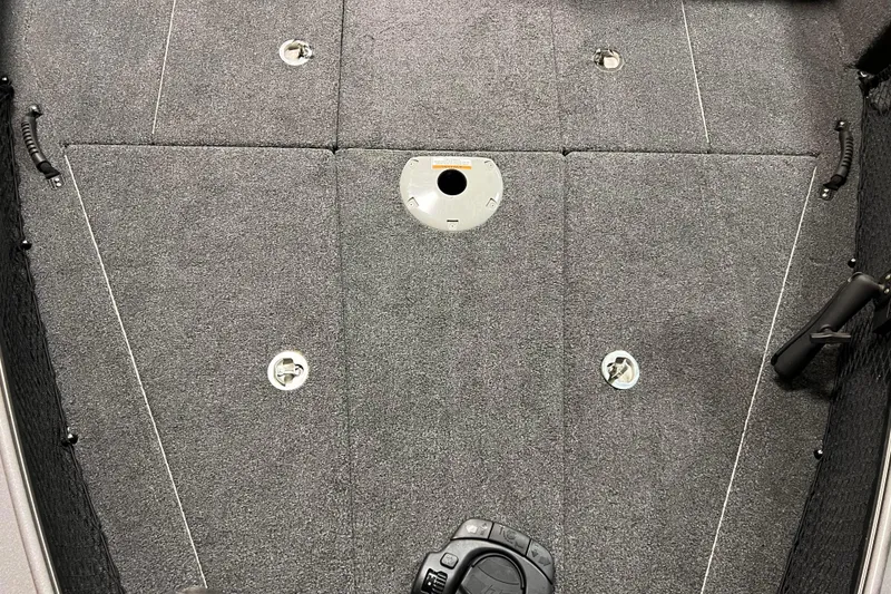 Slide: The Image of 2023 Lund 2175 Pro-V boat deck with gray carpet and storage compartments. - 40