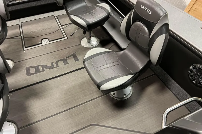 Slide: The Image of 2023 Lund 2175 Pro-V boat interior with sleek seating and branded flooring. - 41