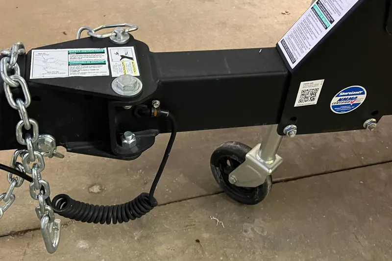 Slide: The Image of Trailer hitch and safety chain of 2023 Lund 2175 Pro-V boat. - 49