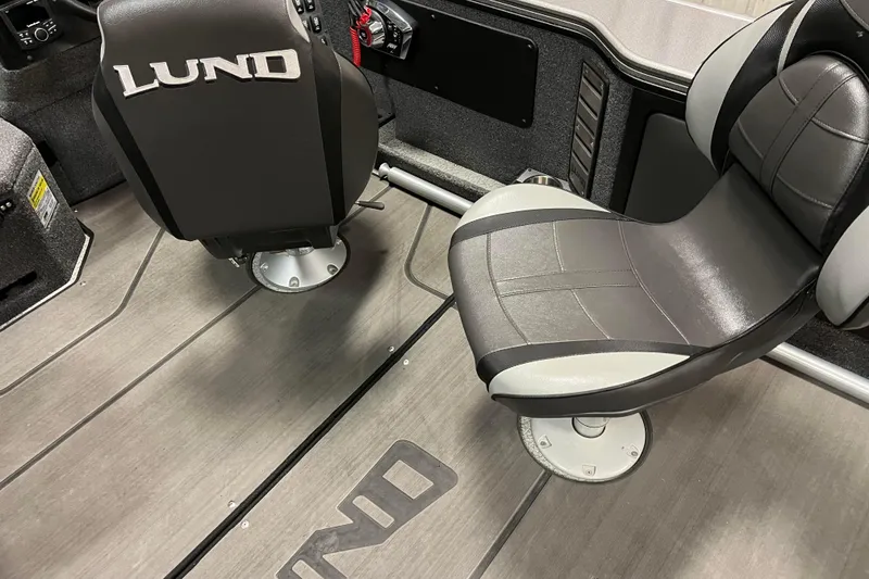 Slide: The Image of 2023 Lund 2175 Pro-V boat interior with branded seating and sleek design. - 5