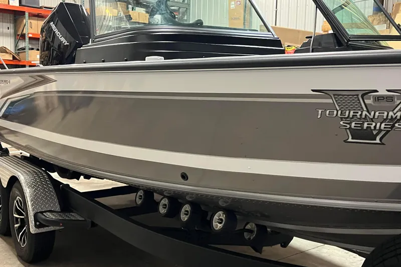 Slide: The Image of 2023 Lund 2175 Pro-V Tournament Series boat on trailer in warehouse. - 54