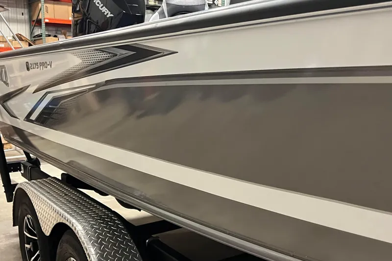 Slide: The Image of 2023 Lund 2175 Pro-V boat on trailer, showcasing sleek design and modern features. - 55