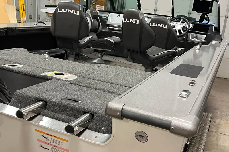 Slide: The Image of 2023 Lund 2175 Pro-V boat interior with seating and control panel. - 60