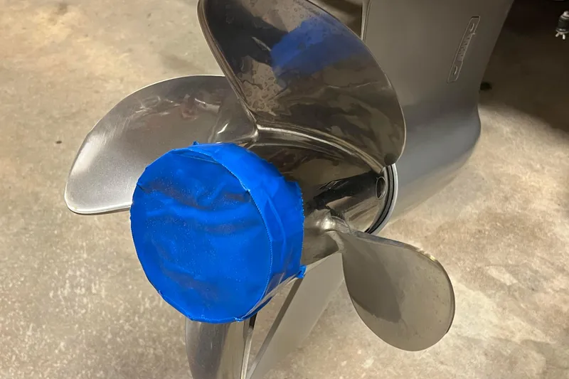 Slide: The Image of 2023 Lund 2175 Pro-V boat propeller with blue tape cover on concrete floor. - 65