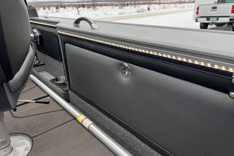 Slide: The Image of 2023 Lund 2175 Pro-V boat interior with LED lighting and storage compartment. - 72