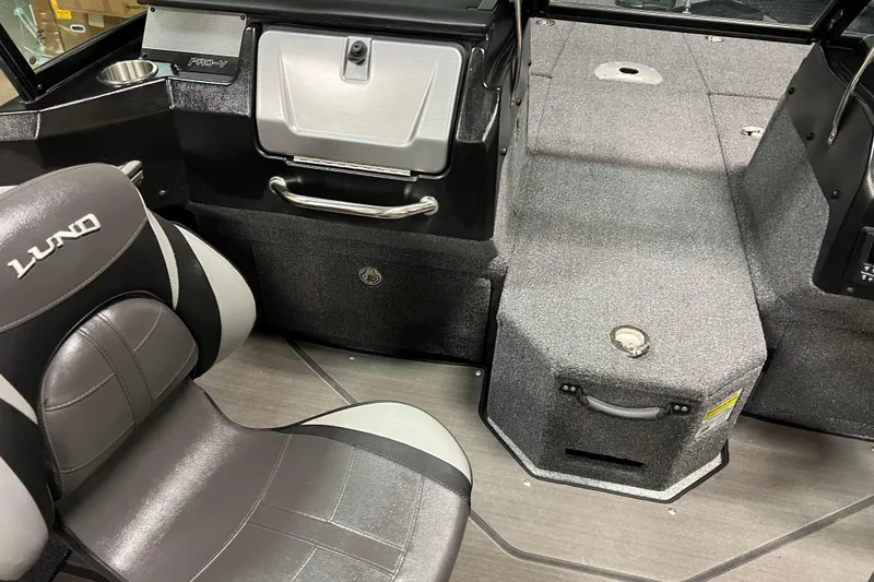 Slide: The Image of 2023 Lund 2175 Pro-V boat interior with seating and storage compartments. - 8