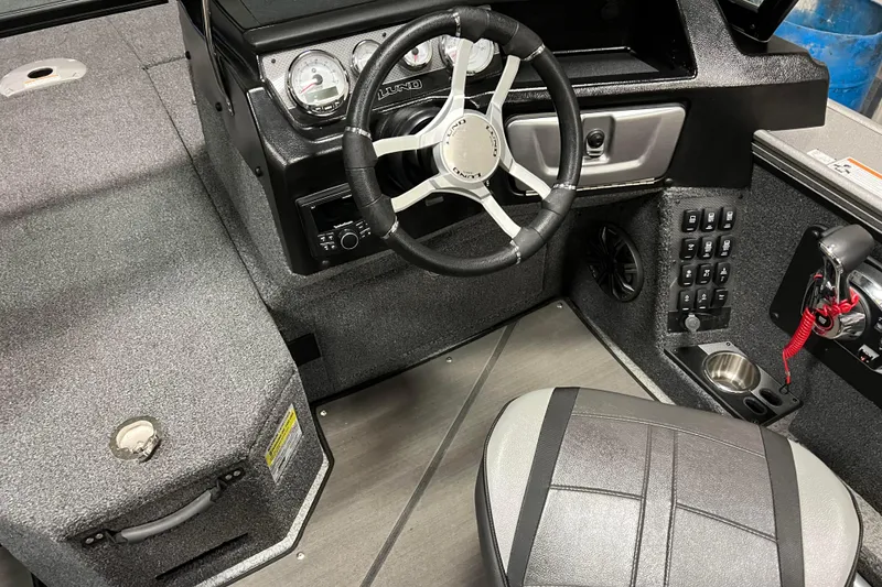 Slide: The Image of 2023 Lund 2175 Pro-V boat interior with steering wheel and control panel. - 9
