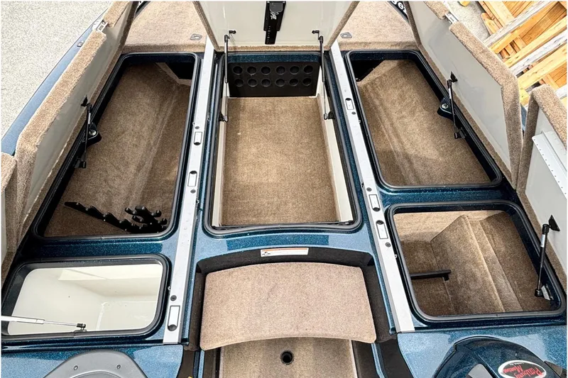 Slide: The Image of 2007 Ranger Z21 Comanche boat storage compartments, open and carpeted, showcasing ample space. - 5