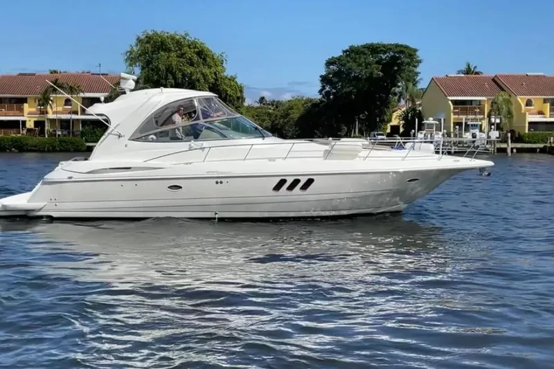 The Image of 2008 Cruisers Yachts 460 Express on water, with residential backdrop. - 0