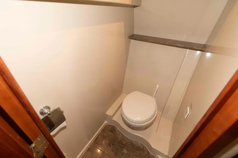 Slide: The Image of 2008 Cruisers Yachts 460 Express bathroom with toilet and marble floor. - 16