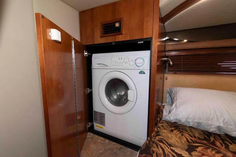 Slide: The Image of Laundry area inside 2008 Cruisers Yachts 460 Express, featuring a built-in washing machine. - 18