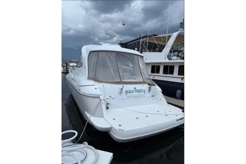 Slide: The Image of 2008 Cruisers Yachts 460 Express docked, overcast sky, marina setting. - 2