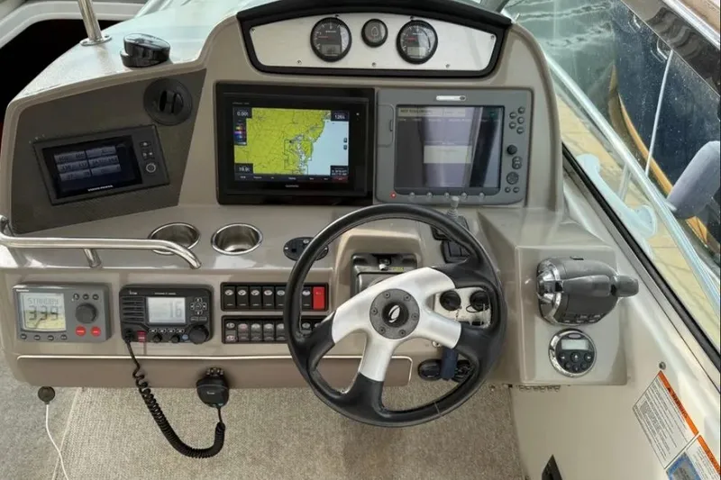 Slide: The Image of 2008 Cruisers Yachts 460 Express helm with navigation screens and controls. - 3