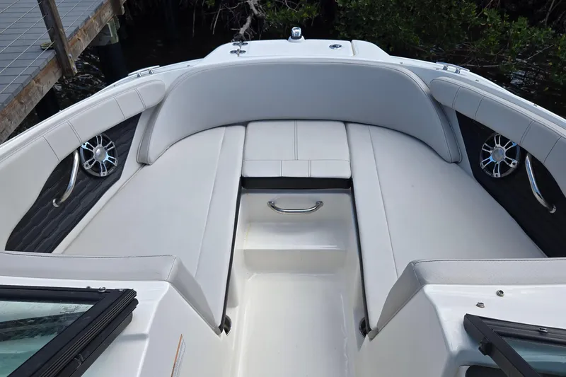Slide: The Image of 2023 Sea Ray SPX 210 boat interior with white seating and speakers. - 21