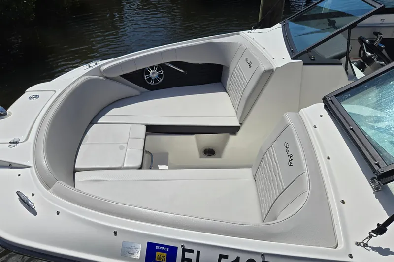 Slide: The Image of 2023 Sea Ray SPX 210 boat interior with white seating and sleek design. - 25