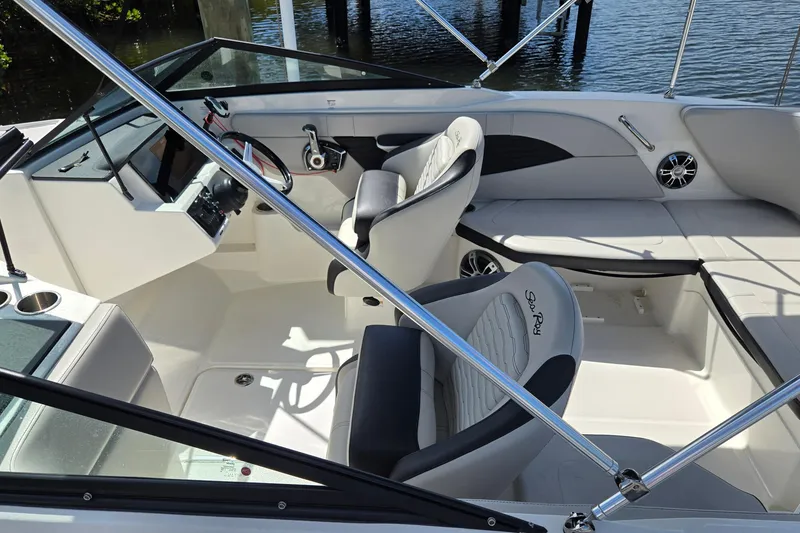 Slide: The Image of 2023 Sea Ray SPX 210 boat interior with modern seating and steering console. - 26
