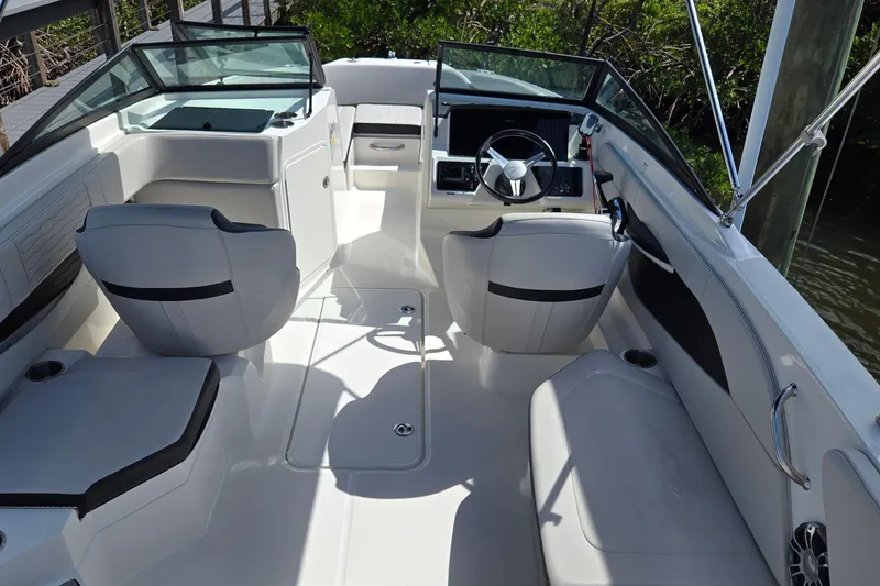 Slide: The Image of 2023 Sea Ray SPX 210 boat interior with modern seating and steering console. - 30