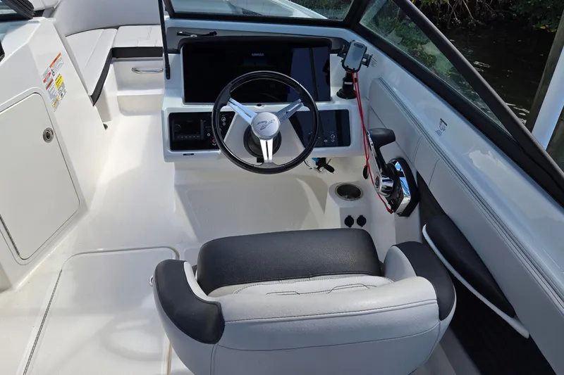 Slide: The Image of 2023 Sea Ray SPX 210 boat cockpit with steering wheel and control panel. - 33