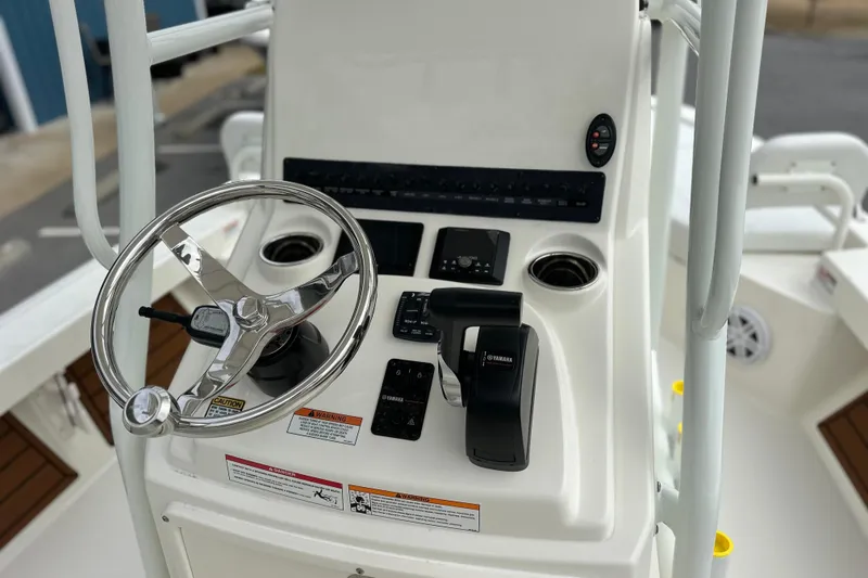 Slide: The Image of 2026 Pathfinder 2200 TRS boat console with steering wheel and controls. - 12