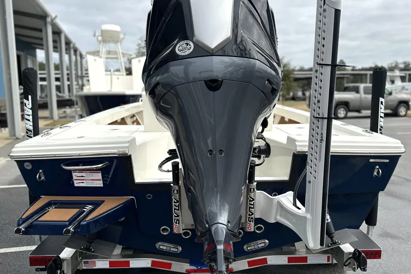 Slide: The Image of 2026 Pathfinder 2200 TRS boat with powerful outboard motor, parked on trailer. - 21