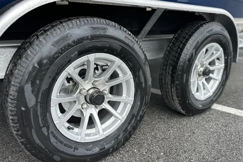 Slide: The Image of Trailer wheels of a 2026 Pathfinder 2200 TRS on wet pavement. - 23