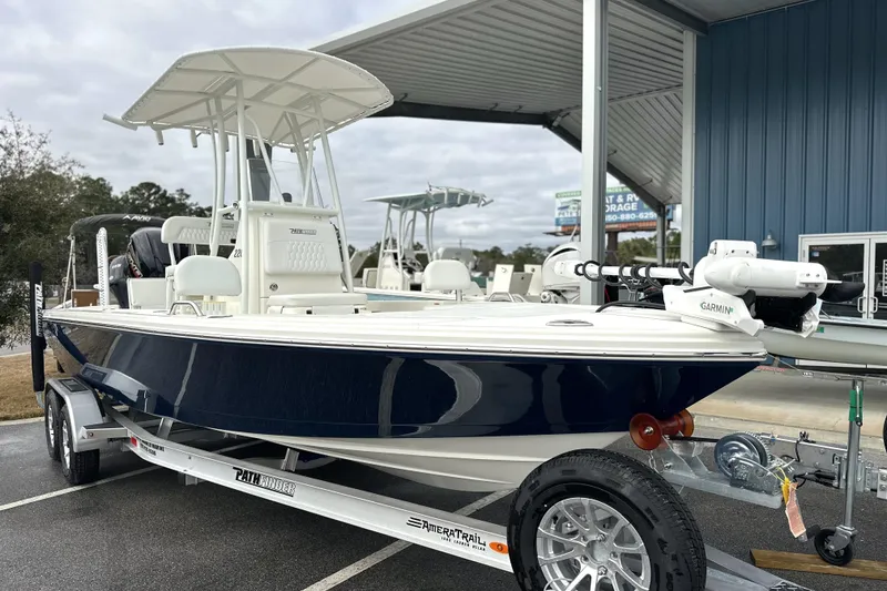 Slide: The Image of 2026 Pathfinder 2200 TRS boat on trailer, displayed outdoors near a blue building. - 27