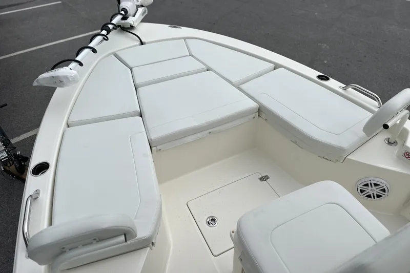 Slide: The Image of 2026 Pathfinder 2200 TRS boat interior with white cushioned seating and storage compartments. - 5
