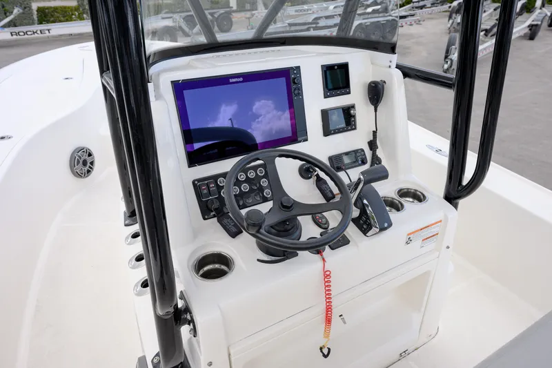 Slide: The Image of 2024 SeaVee 270Z boat console with steering wheel, navigation screens, and controls. - 10