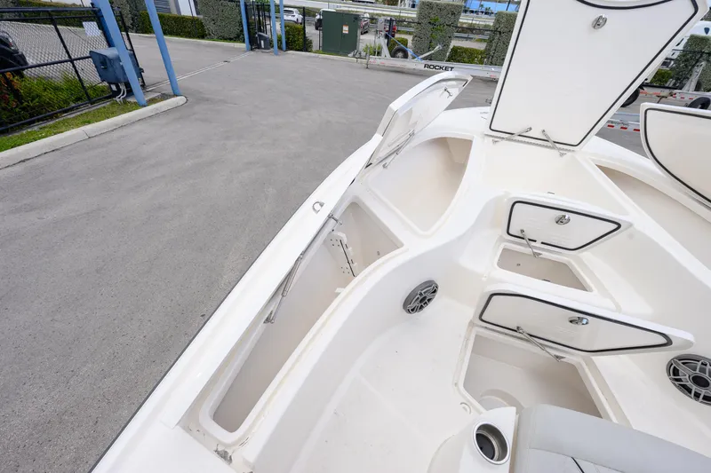 Slide: The Image of 2024 SeaVee 270Z boat deck with open storage compartments and seating area. - 11