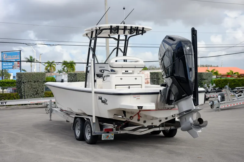 Slide: The Image of 2024 SeaVee 270Z boat on trailer, featuring powerful outboard motor, parked outdoors. - 4