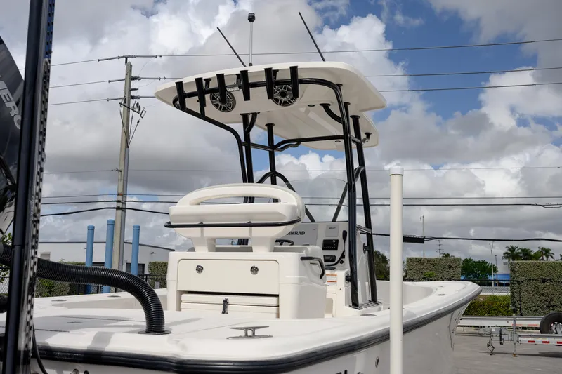Slide: The Image of 2024 SeaVee 270Z boat with T-top and console, under cloudy sky. - 7