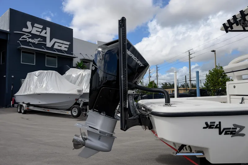 Slide: The Image of 2024 SeaVee 270Z boat with Mercury engine at SeaVee dealership under cloudy sky. - 8