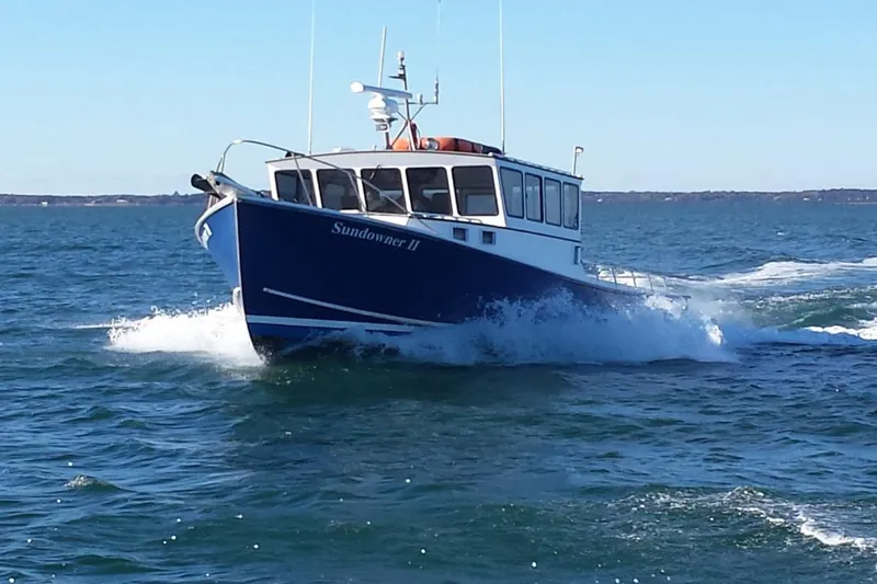 The Image of A 1985 Young Brothers 40 boat, "Sundowner II," cruising on open water. - 1