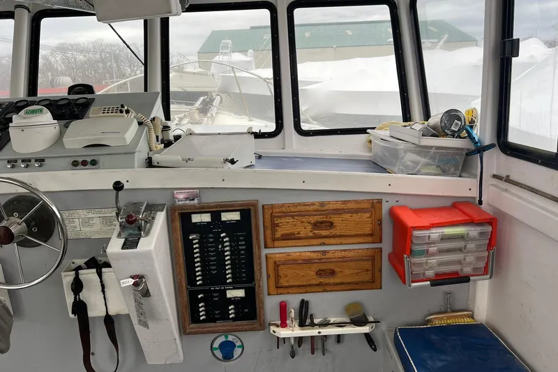 Slide: The Image of Interior of a 1985 Young Brothers 40 boat, featuring control panel and storage compartments. - 11