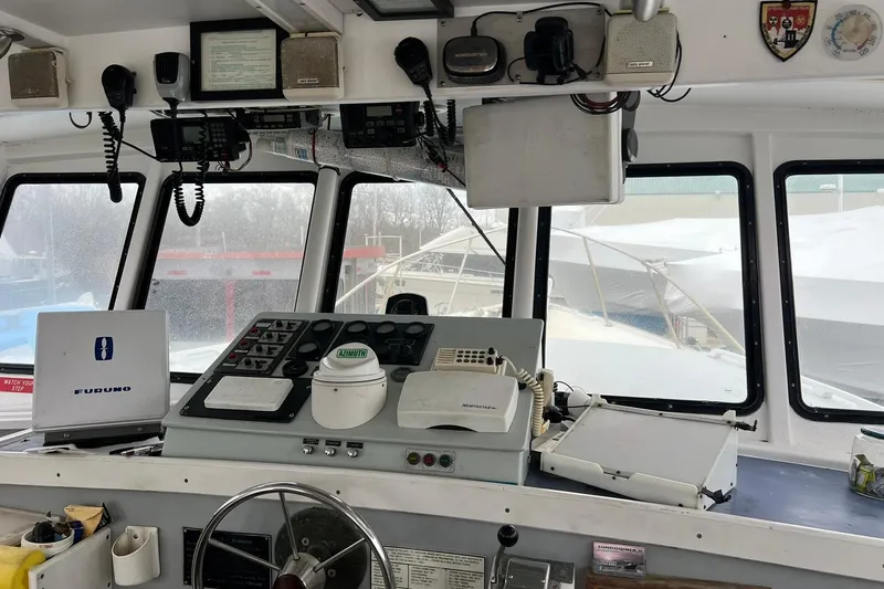 Slide: The Image of Interior of 1985 Young Brothers 40 boat with navigation equipment and control panel. - 12