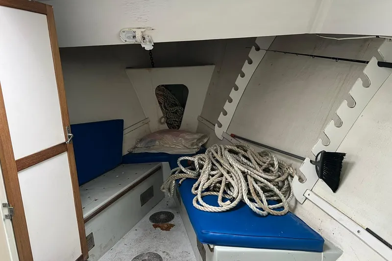Slide: The Image of Interior of 1985 Young Brothers 40 boat with ropes and blue cushions. - 18