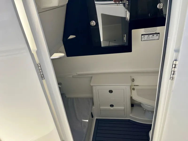 Slide: The Image of Interior of 2026 Cobia 350 Center Console with toilet and storage. - 21