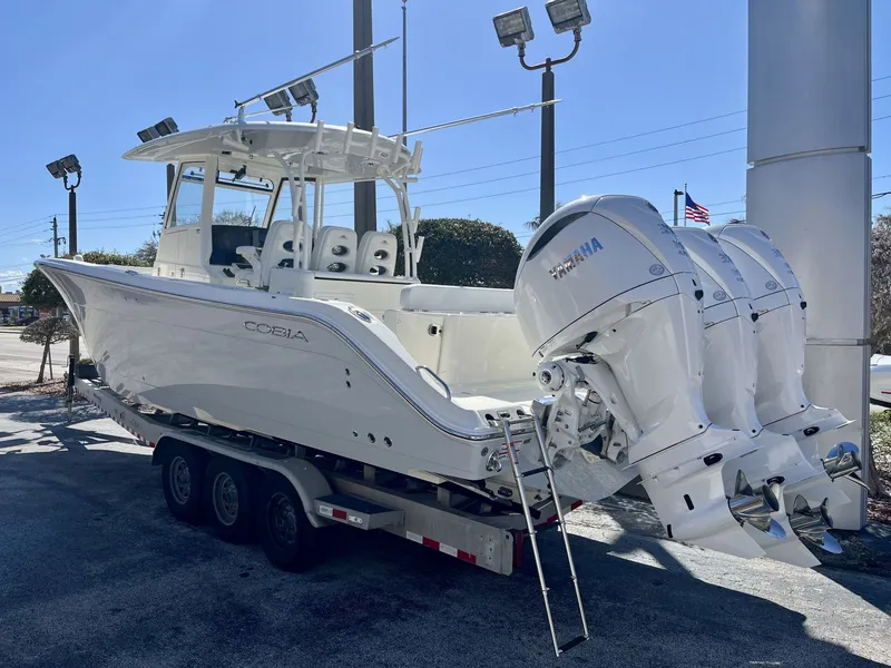Slide: The Image of 2026 Cobia 350 Center Console boat with Yamaha engines on trailer. - 4