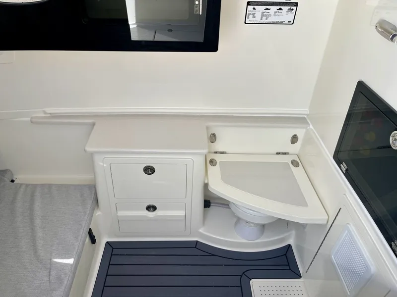 Slide: The Image of Interior of 2026 Cobia 350 Center Console with toilet and storage. - 23