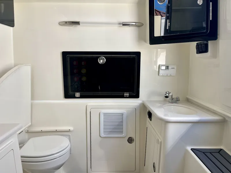 Slide: The Image of Interior of 2026 Cobia 350 Center Console with toilet and sink. - 25