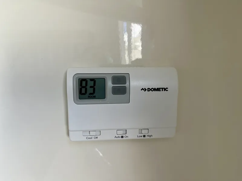 Slide: The Image of Dometic thermostat displaying 83 degrees on 2026 Cobia 350 Center Console. - 26