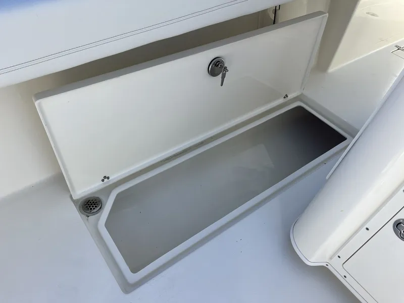 Slide: The Image of Open storage compartment on a 2026 Cobia 350 Center Console boat. - 49