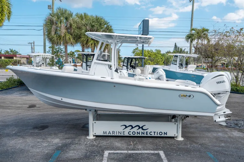 Slide: The Image of Sea Hunt Ultra 234 boat 2026 displayed on a parking lot. - 5