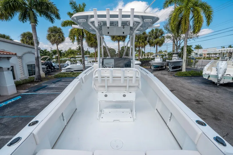Slide: The Image of 2026 Sea Hunt Ultra 234 boat in marina, surrounded by palm trees. - 9