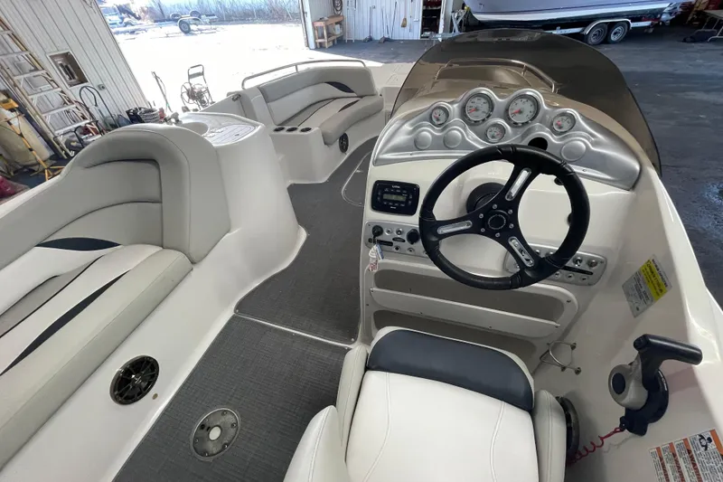 Slide: The Image of Interior of a 2016 Starcraft Coastal 2009 OB boat with steering wheel and seating. - 11