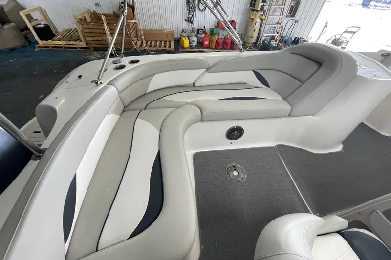 Slide: The Image of Interior of a 2016 Starcraft Coastal 2009 OB boat with cushioned seating. - 12
